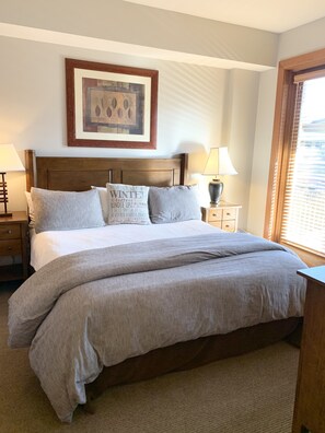 King size master bedroom ensuite w/ private balcony overlooking ice rink.