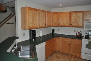 Kitchen includes dishwasher along with coffee, tea, and condiments.