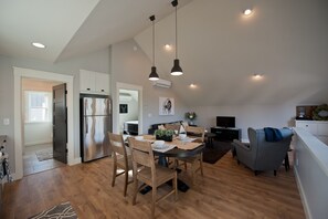 open living dining kitchen with vaulted ceilings