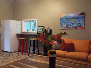 Full size refrigerator with granite bar counter for preping inside the studio.