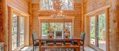 Dining Room with antler chandelier, ski run, mountain views out the door