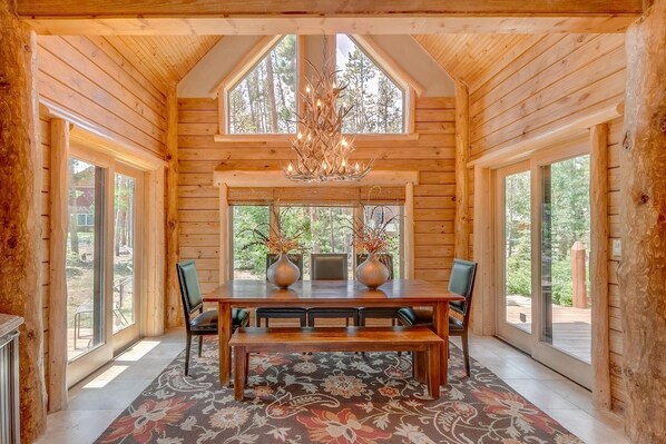 Dining Room with antler chandelier, ski run, mountain views out the door