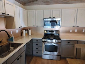 New kitchen with quartz countertops, copper backsplassh and gooseneck fucet