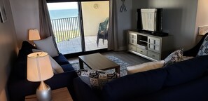 Living Area with 50" TV and Balcony Access
