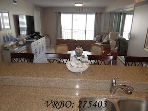Breakfast bar from kitchen, dining, and living area from kitchen