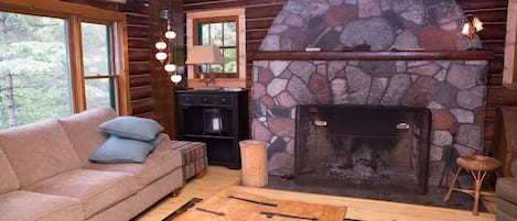 The living room is gorgeous with a fieldstone fireplace and view of the river.
