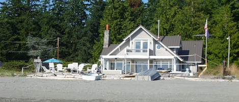 View of the house from the water. Master bedroom french doors on upper level