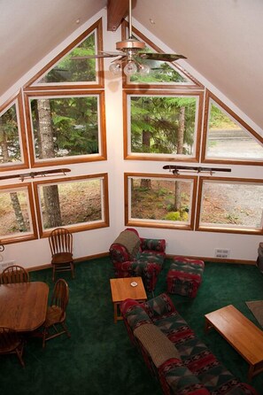 View of dining room and living room from above. Windows to the ceiling!