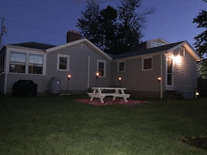 Private Backyard with picnic table, grill, and fire pit