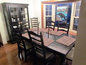 The dining area is in front of a large bay window with a great view of the lake.