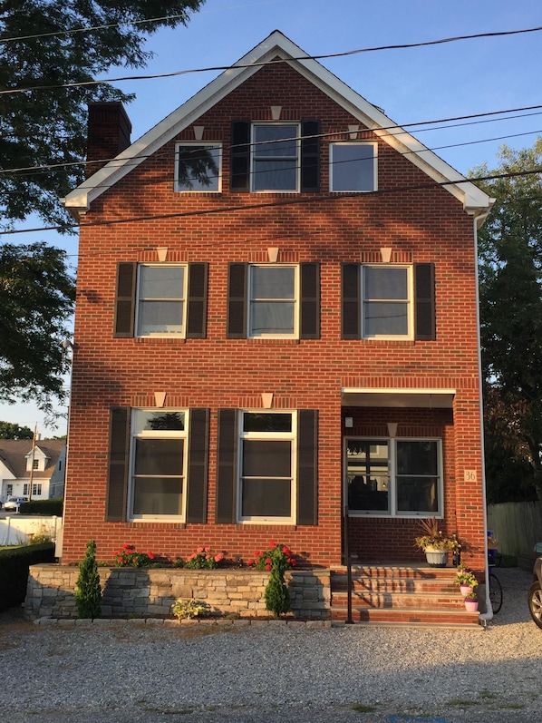All brick, three story house with parking for 5 cars.