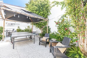 The interior courtyard's lush garden gives plenty of privacy and ambiance, with fountain, ping pong table, canopy, and propane BBQ grill for casual, al fresco evenings.
                