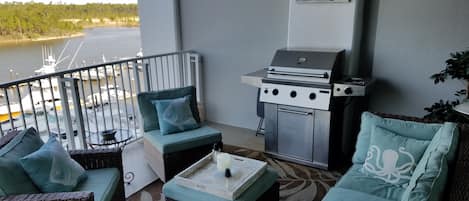 Cozy outdoor patio w/ gas grill. A lovely view of intracoastal waterway & marina