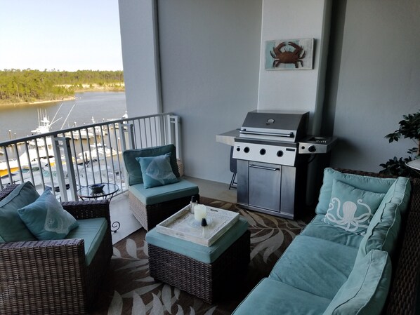 Cozy outdoor patio w/ gas grill. A lovely view of intracoastal waterway & marina