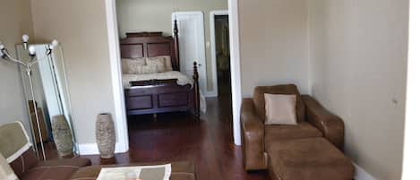 Living room with French doors leading to the first bedroom. 