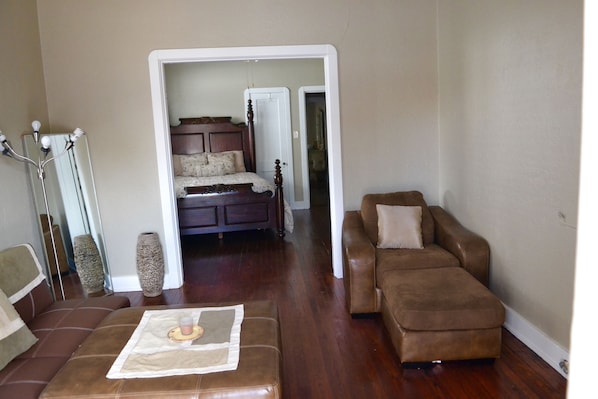 Living room with French doors leading to the first bedroom. 