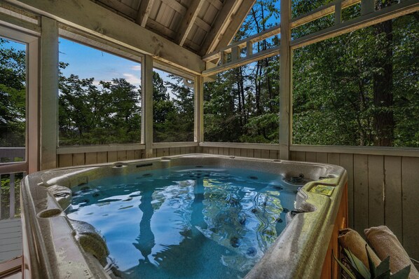 Large hot tub on screened in porch