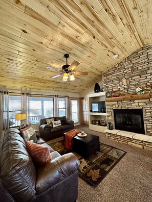 Living Room w/ Floor to ceiling fireplace. TV w/ Dish satellite and chromecast