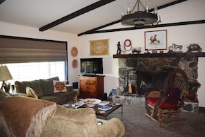Spacious living room is roomy and comfortable  with interesting western decor.