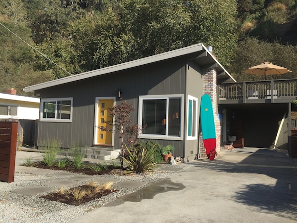 Front of house. driveway accommodates two cars, in addition to carport
