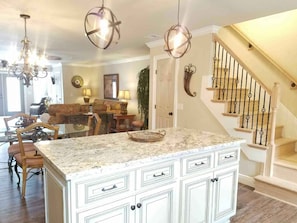 Custom kitchen with walk around island. All new slate appliances. 
