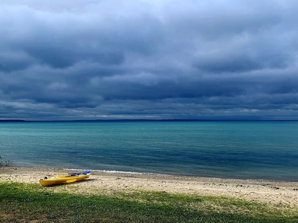 Private sandy beach with glowing blue waters