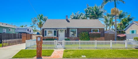 View of the home from the street, 2 car driveway to left of the home. Fully fenced in yard for the kids and furry friends.