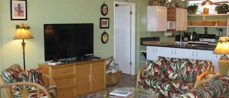 Open floor plan with new 55-inch Smart TV and newly upholstered furniture.