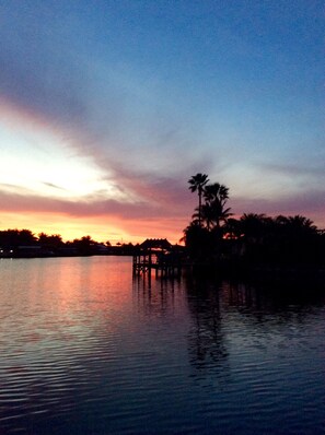 Sunsets over tropical wide water view. Relax and enjoy!