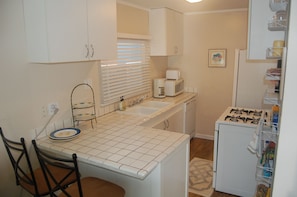 Fully stocked kitchen with bar counter.