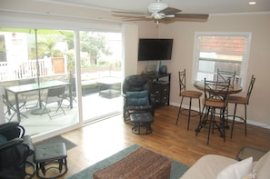 Family room with large sliding glass door that opens to front patio.