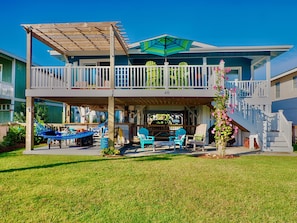 Massive rear deck with pergola and multiple dining and seating areas.