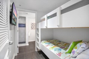Bunk room with a door for added privacy and private bath