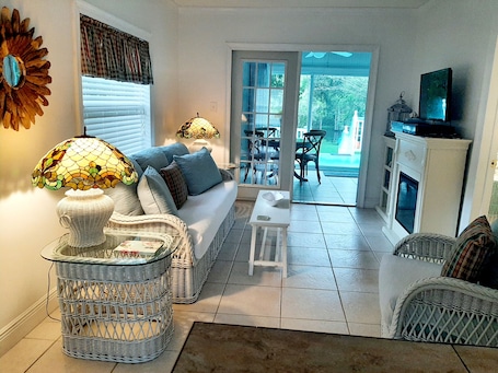 Living room looking out to Fun room, 20 foot tiered deck and River view.