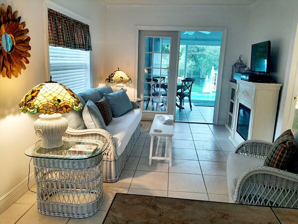 Living room looking out to Fun room, 20 foot tiered deck and River view. 