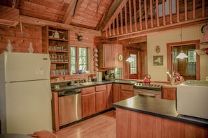 The kitchen greets you upon entry and is fully equipped.