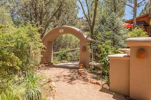 Lighted entry path way with beautiful landscape.