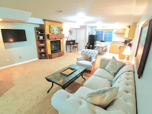 Huge living room with plenty of light, and tall ceilings. Large roku TV.