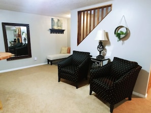 Newly furnished reading nook with comfy chairs and plenty of light.