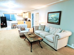 Huge living room with plenty of light, and tall ceilings. Open concept kitchen.