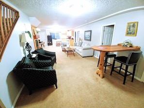 Huge living room with plenty of light, and tall ceilings. Large roku TV