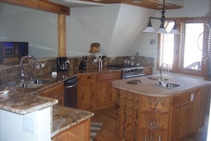 Main House Kitchen. Center island, gas stove, granite counters, fully equipped