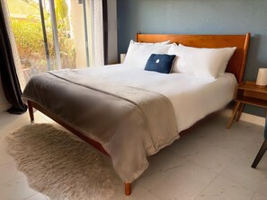 Master bedroom with king bed, smart tv, working desk, ensuite bathroom and patio