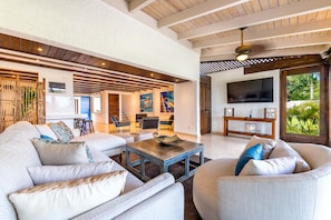 Alternative view of the living room, seated between the kitchen and pool area