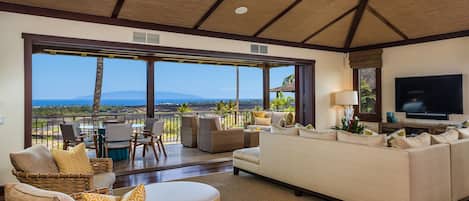 Abundant natural light and ocean views in the living area, with sliding glass pocket doors out to the lanai.
