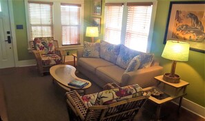 Retro-chic living room features 1950s tropical rattan & barkcloth.