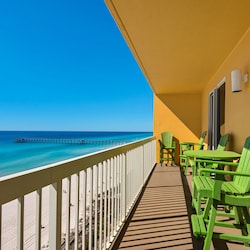 Gulf front balcony with 6 chairs and a table. This is a view to the west.