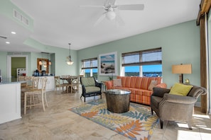 Living room, dining room, coffee bar & kitchen countertop with bar stools.