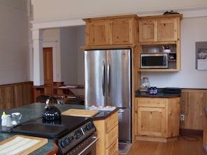 Upstairs kitchen showing stove and refrigerator