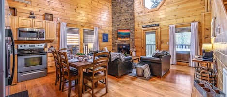 Floor to ceiling stack stone fireplace makes a grand entrance upon arrival.